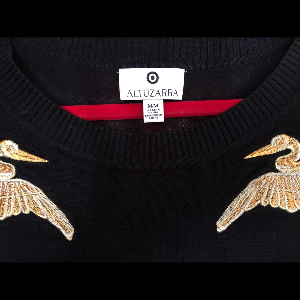 Altuzarra black and gold sweater.